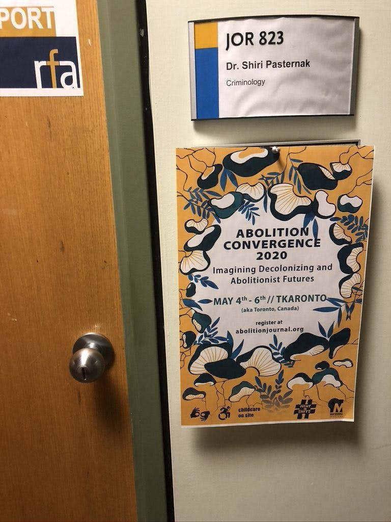 Photo of Shiri's office door with a poster for the 2020 Abolition Convergence