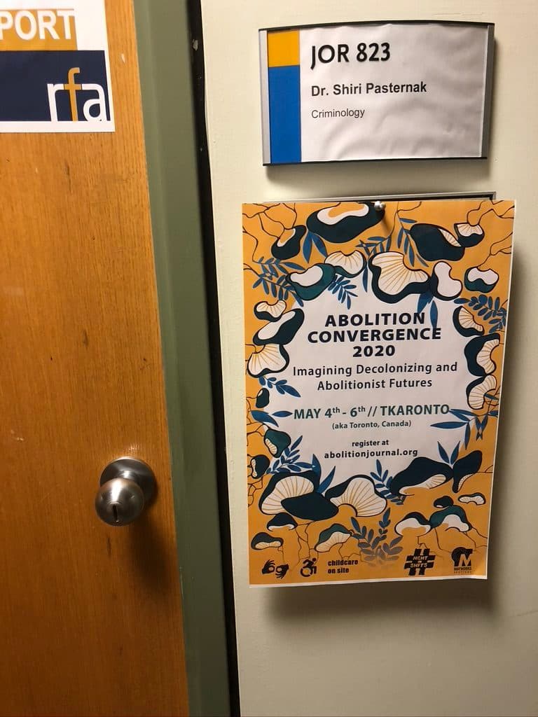 Photo of Shiri's office door with a poster for the 2020 Abolition Convergence